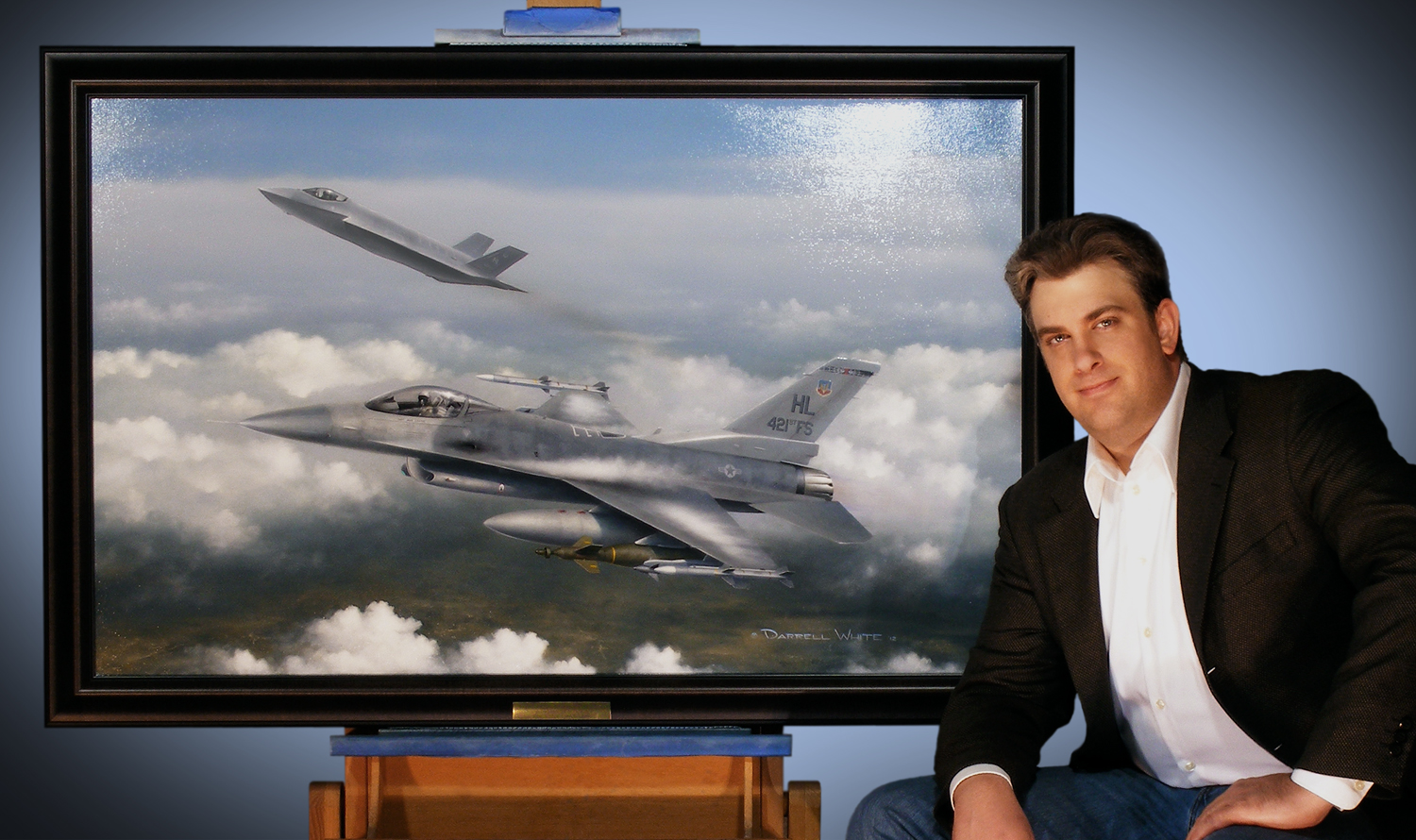Darrell White standing beside one of his original oil paintings of an F-16 Fighting Falcon on his studio easel