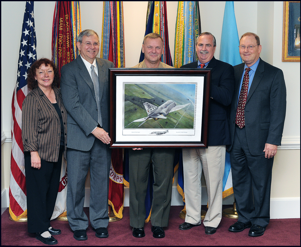 Darrell White and others presenting a framed print of Shamrock 201: Fangs Out to Gen. James Cartwright, Vice Chairman of the Joint Chiefs of Staff, at the Pentagon