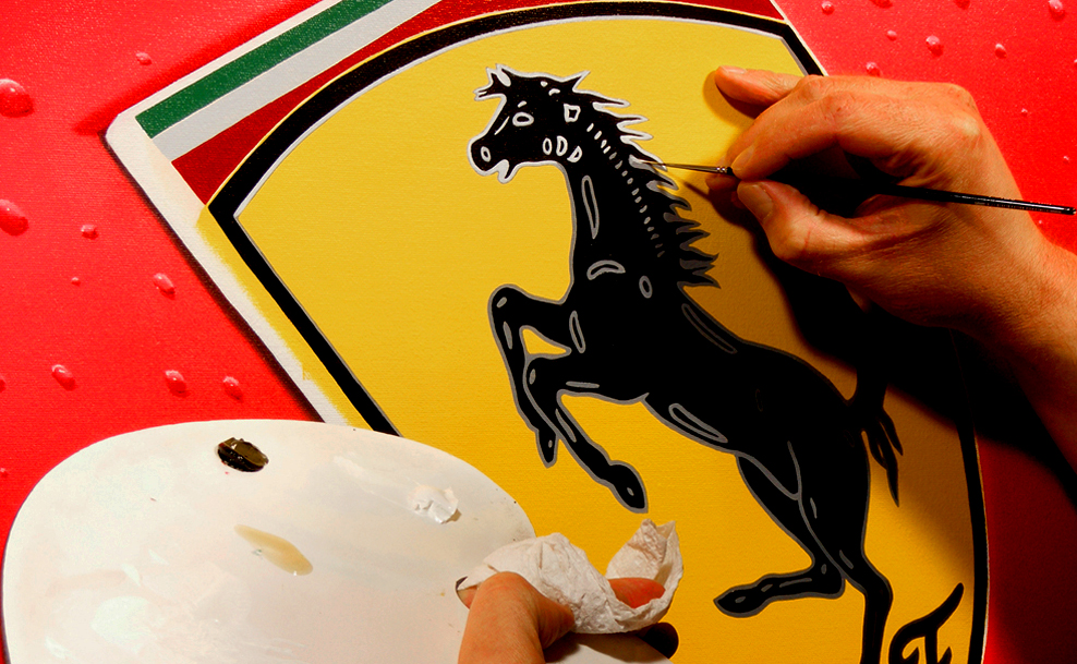Darrell White's hand painting the prancing horse on a Ferrari shield emblem